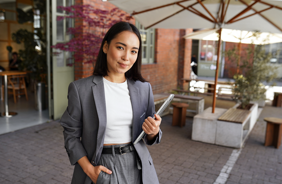 Image of a woman with a laptop wearing business attire